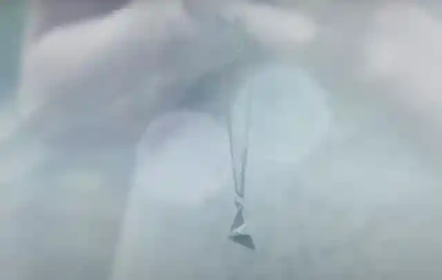 The paper plane necklace in the Style music video